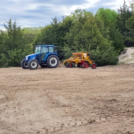 Drilling native grass seed at a stream restoration project