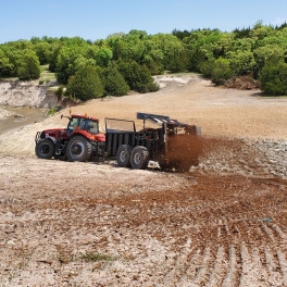 Woody Biomass Utilization - Spreading wood chips on re-seeding efforts