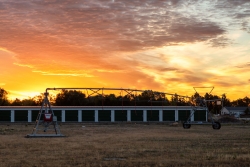 Irrigation pivot behind office building