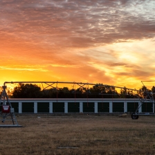 Irrigation pivot behind office building